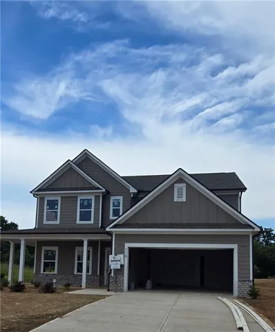 Two-story residence featuring a gray siding exterior with white trim accents and a covered front porch