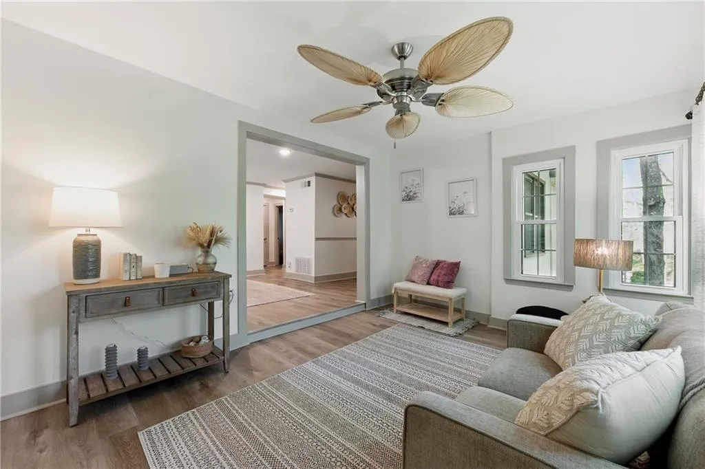 Living area featuring wood finished floors and ceiling fan