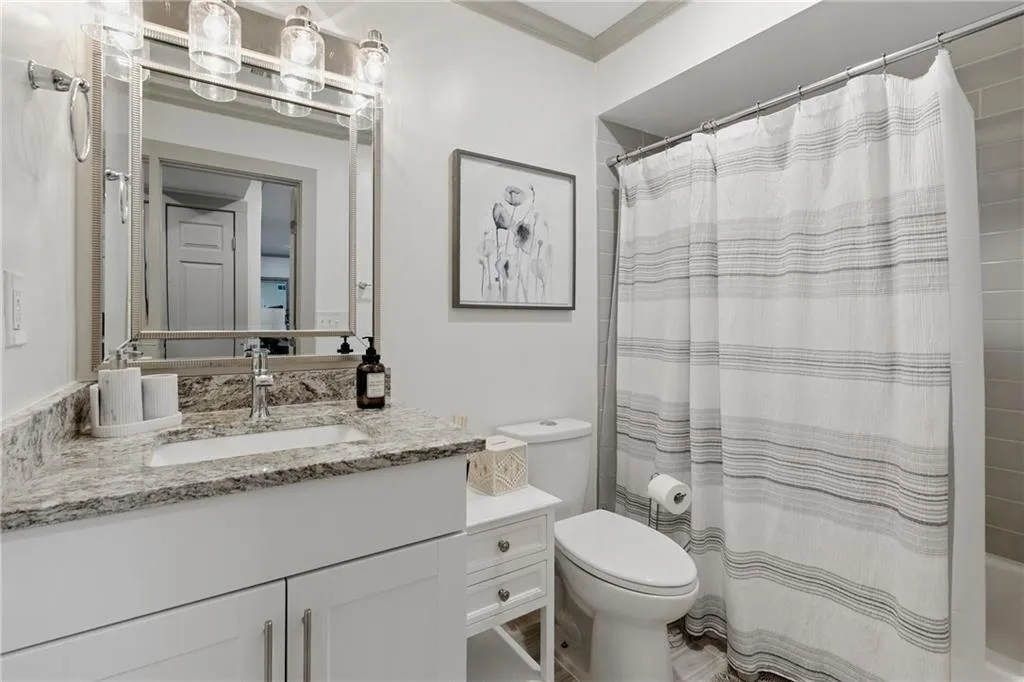 Bathroom featuring vanity and shower / tub combo with curtain