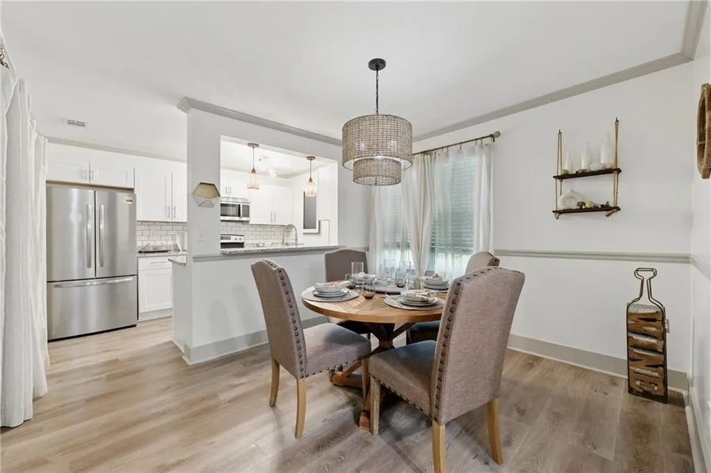 Dining room featuring light wood-style flooring and baseboards