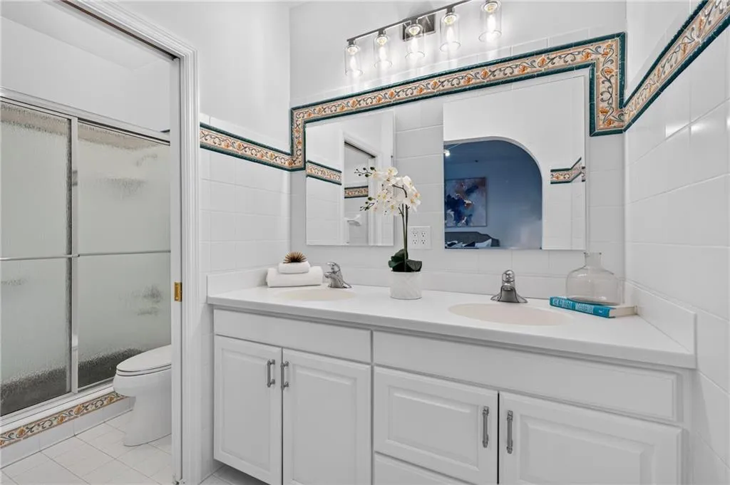 Dual vanity with white cabinetry and integrated sinks