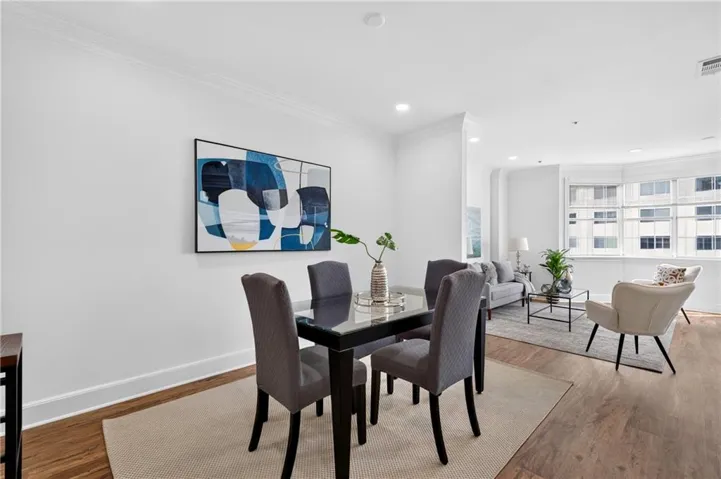 Dining area featuring LVP flooring and crown molding