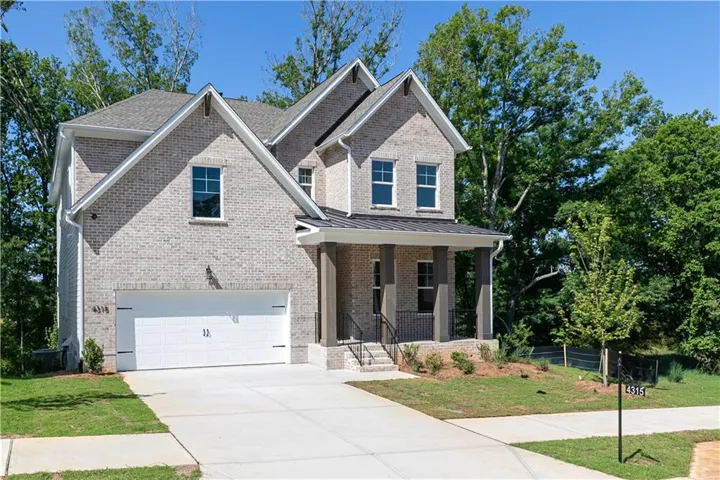 Brick exterior with gabled roof lines and a covered front entry