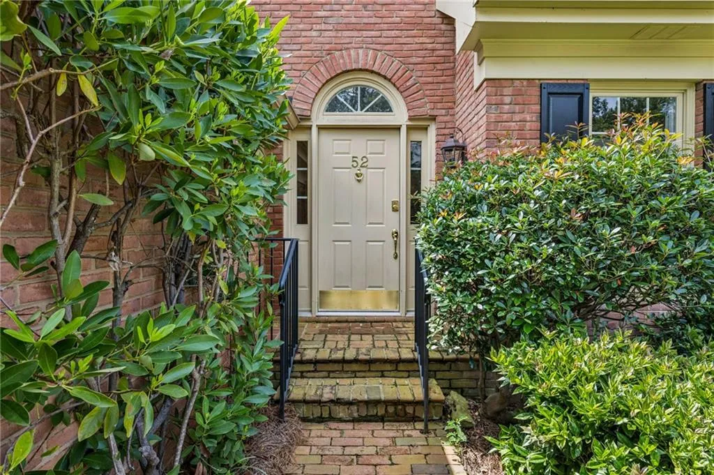 Property entrance featuring brick siding