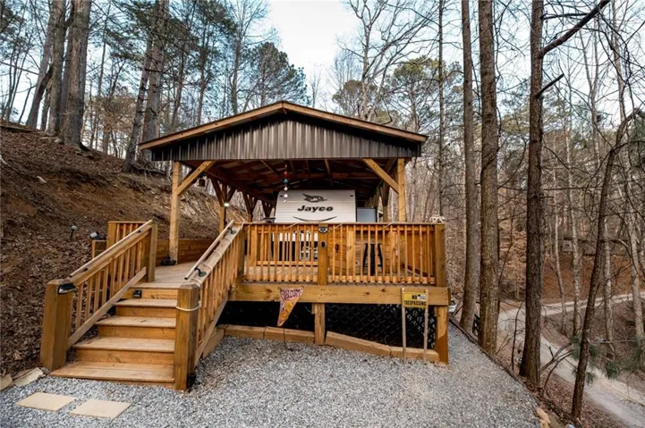 View of front of home featuring a deck and a carport