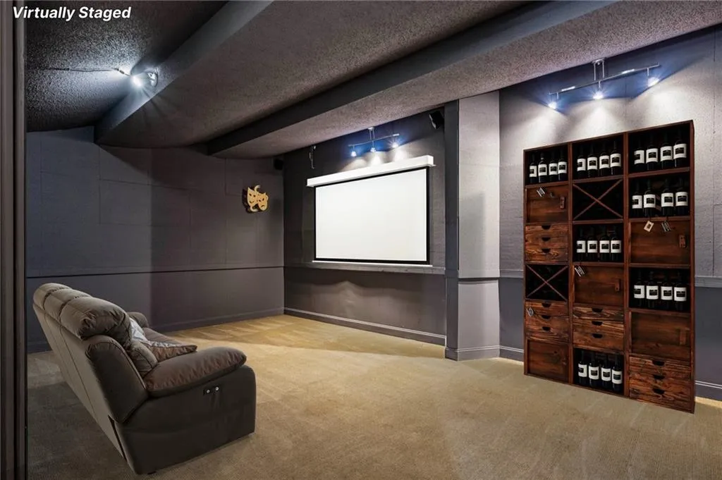 Cinema room with carpet flooring, a textured ceiling, and a textured wall