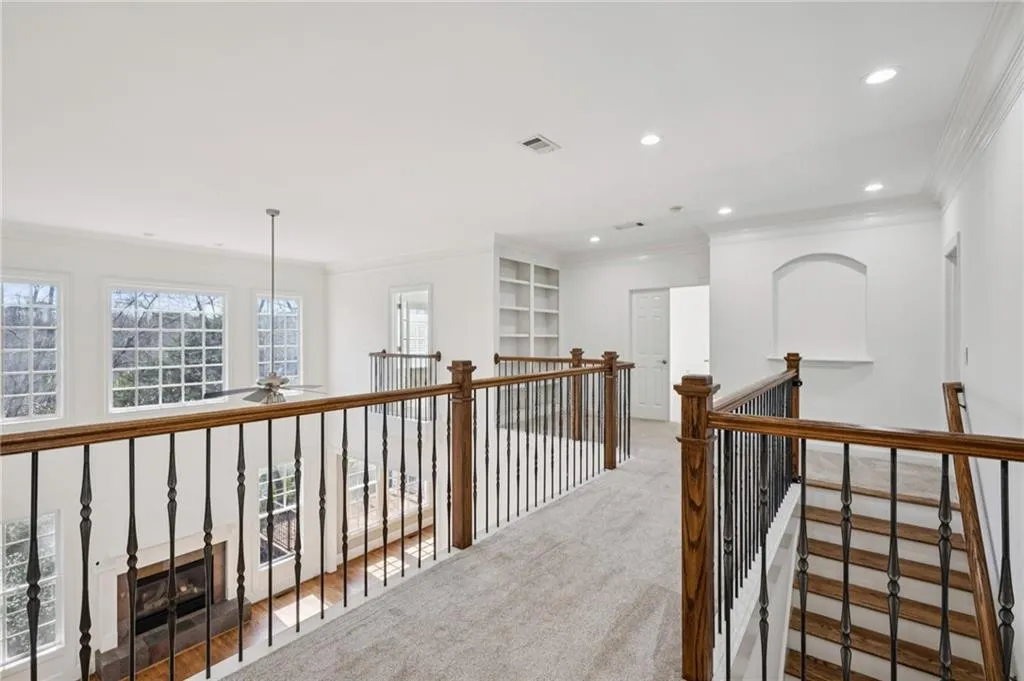 Corridor featuring crown molding, carpet flooring, and recessed lighting
