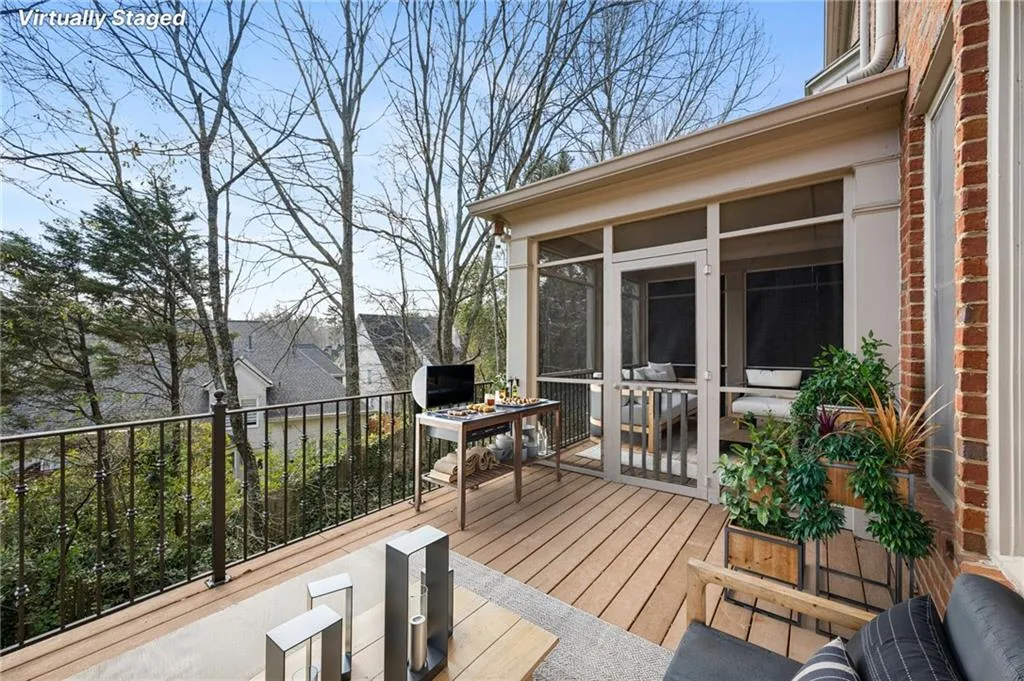 Deck featuring a sunroom and outdoor dining space