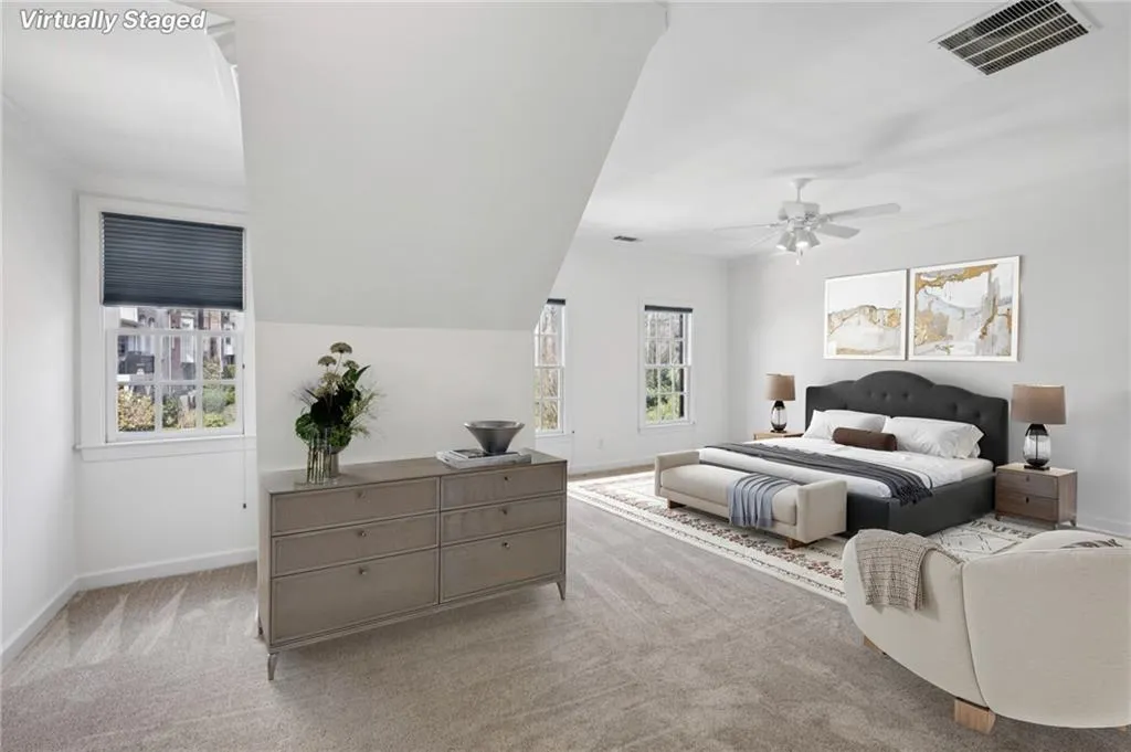 Bedroom with light carpet, ceiling fan, and crown molding