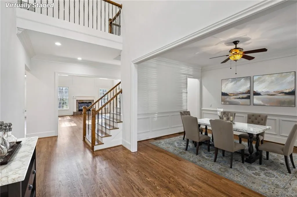 Dining area featuring ornamental molding, dark wood-style floors, a ceiling fan, a fireplace, and recessed lighting