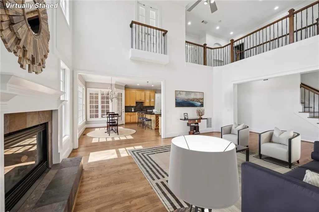 Living area featuring a ceiling fan, a fireplace, light wood finished floors, recessed lighting, and ornamental molding