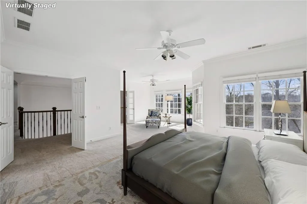 Bedroom featuring ornamental molding, carpet flooring, and ceiling fan