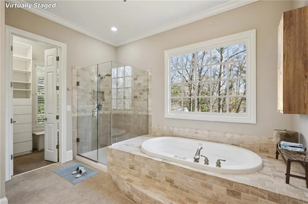 Bathroom featuring a stall shower, a garden tub, tile patterned floors, ornamental molding, and recessed lighting