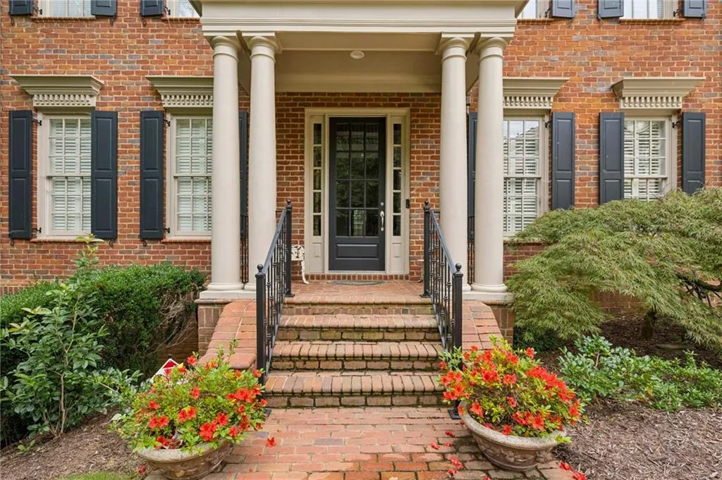 View of exterior entry with brick siding