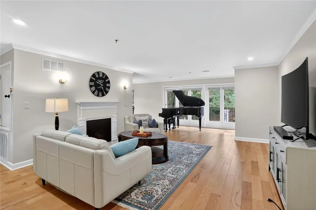 Living area featuring ornamental molding, a fireplace, recessed lighting, and light wood finished floors