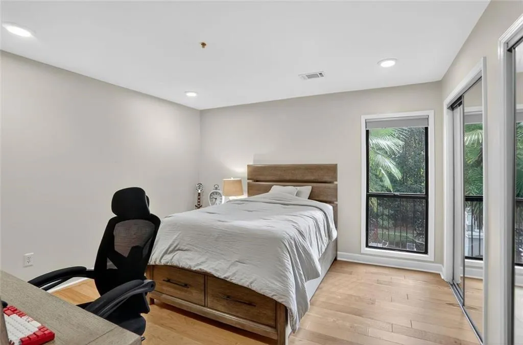 Bedroom with light wood-type flooring and recessed lighting