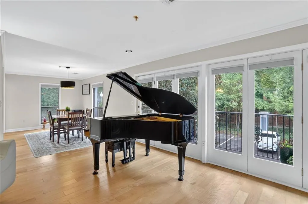 Sitting room featuring crown molding and light wood-style floors