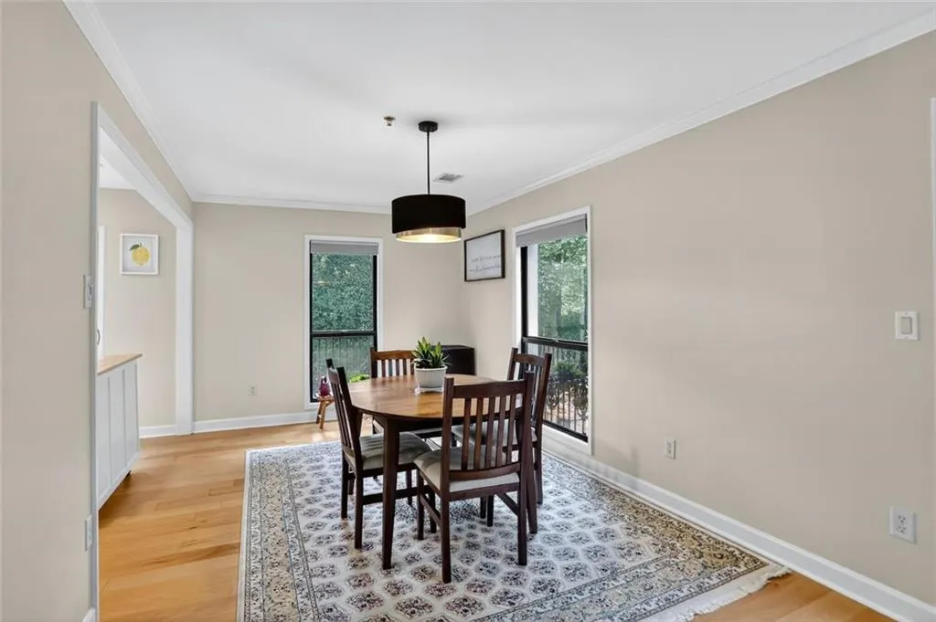 Dining room featuring crown molding and light wood-style flooring