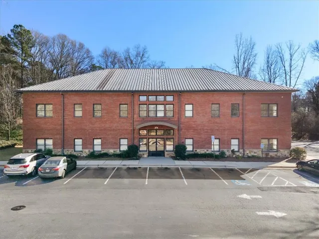 View of commercial location featuring uncovered parking