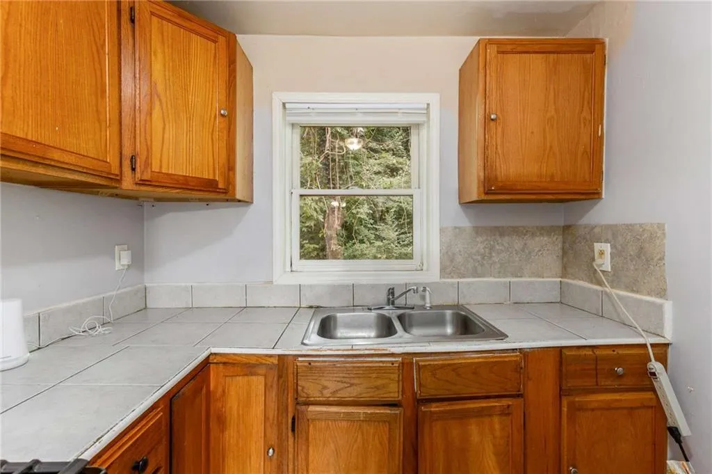 Kitchen featuring brown cabinets and tile counters