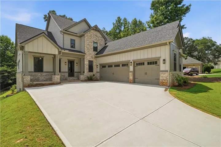 Modern farmhouse exterior featuring board and batten siding and stone accents