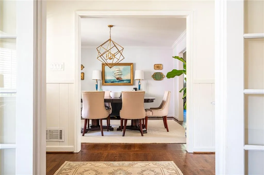 Entering into the foyer brings you to the masterfully created dining room complete with wainscoting, ornamental molding, and a perfect chandelier