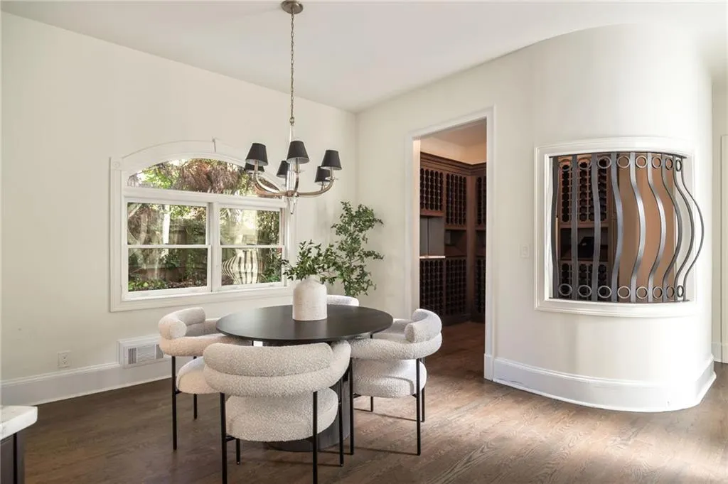Dining room with dark wood-style floors and a chandelier