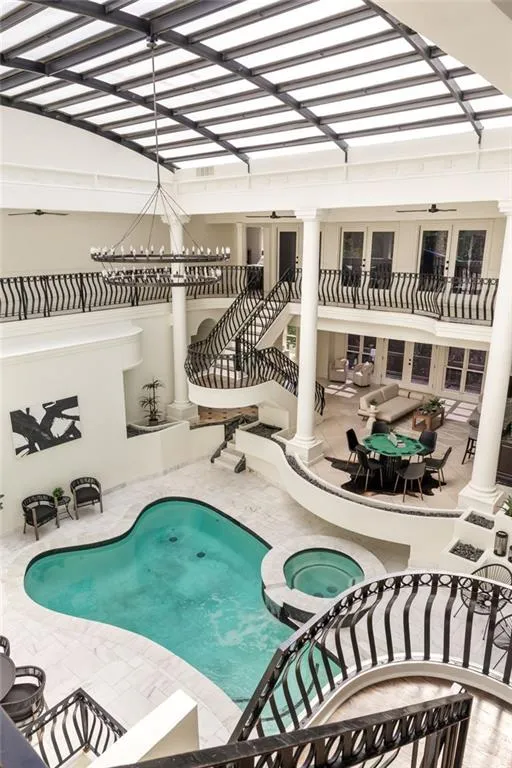 View of swimming pool with stairs, outdoor dining area, a patio area, and a pool with connected hot tub