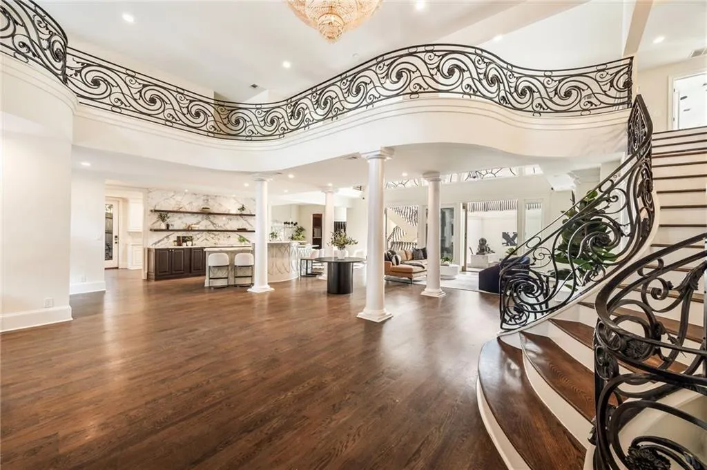 Building lobby featuring stairs, a towering ceiling, and recessed lighting