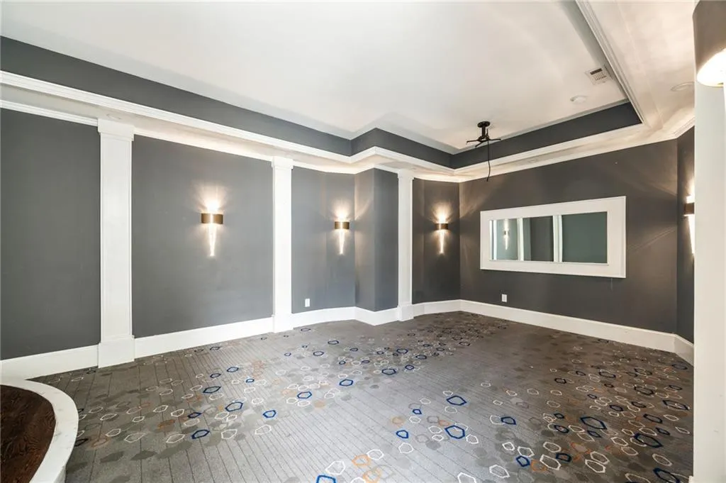 Unfurnished room featuring a raised ceiling and ornamental molding