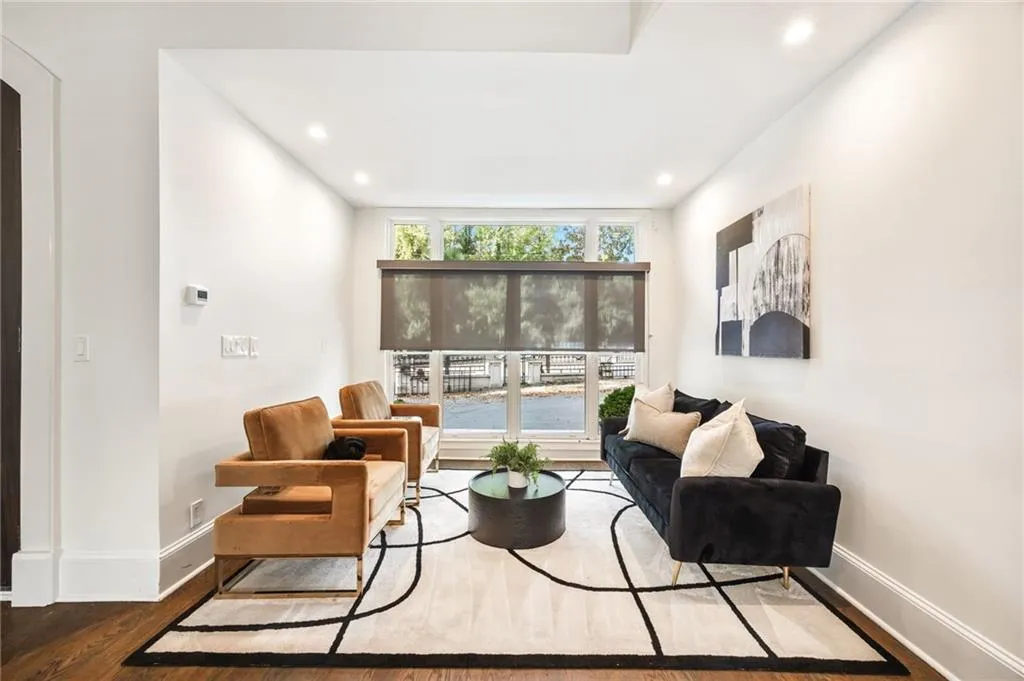 Living area featuring wood finished floors and recessed lighting