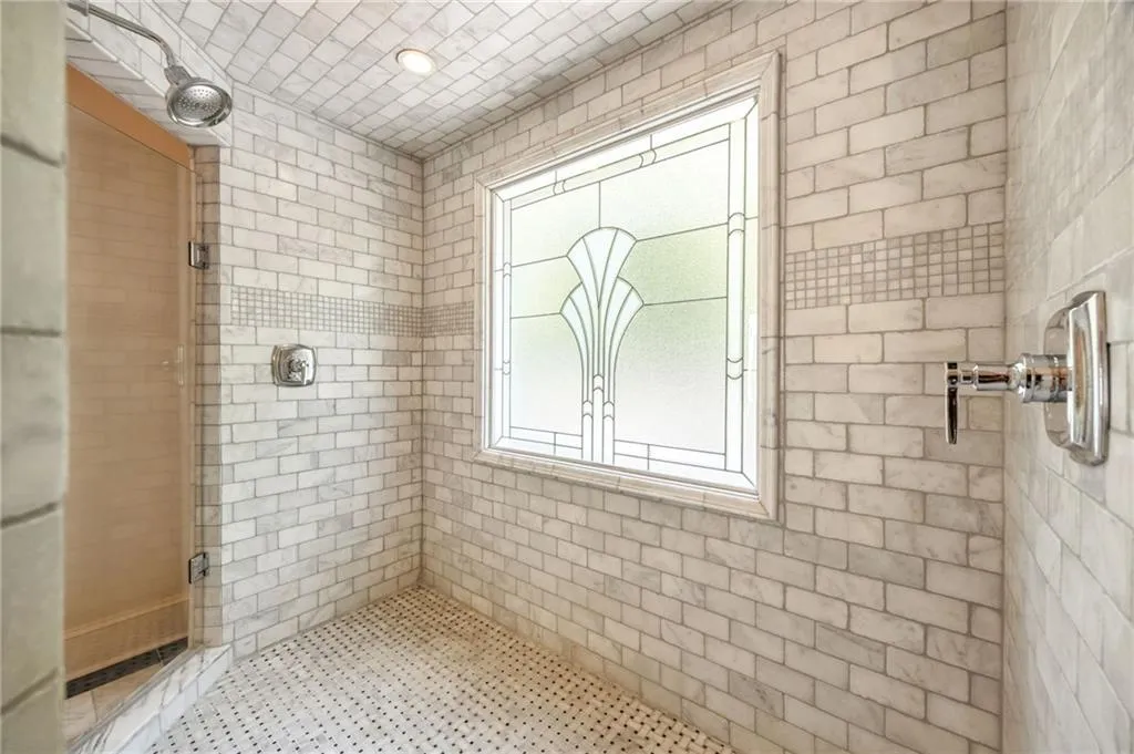 Full bathroom with a shower stall and recessed lighting