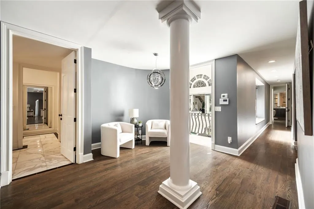 Hallway featuring dark wood finished floors, a chandelier, and recessed lighting