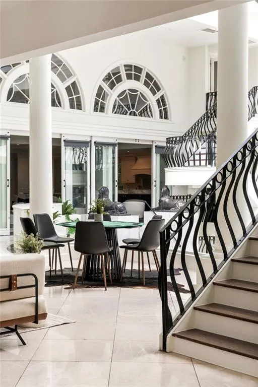 Community lobby featuring stairs and a towering ceiling
