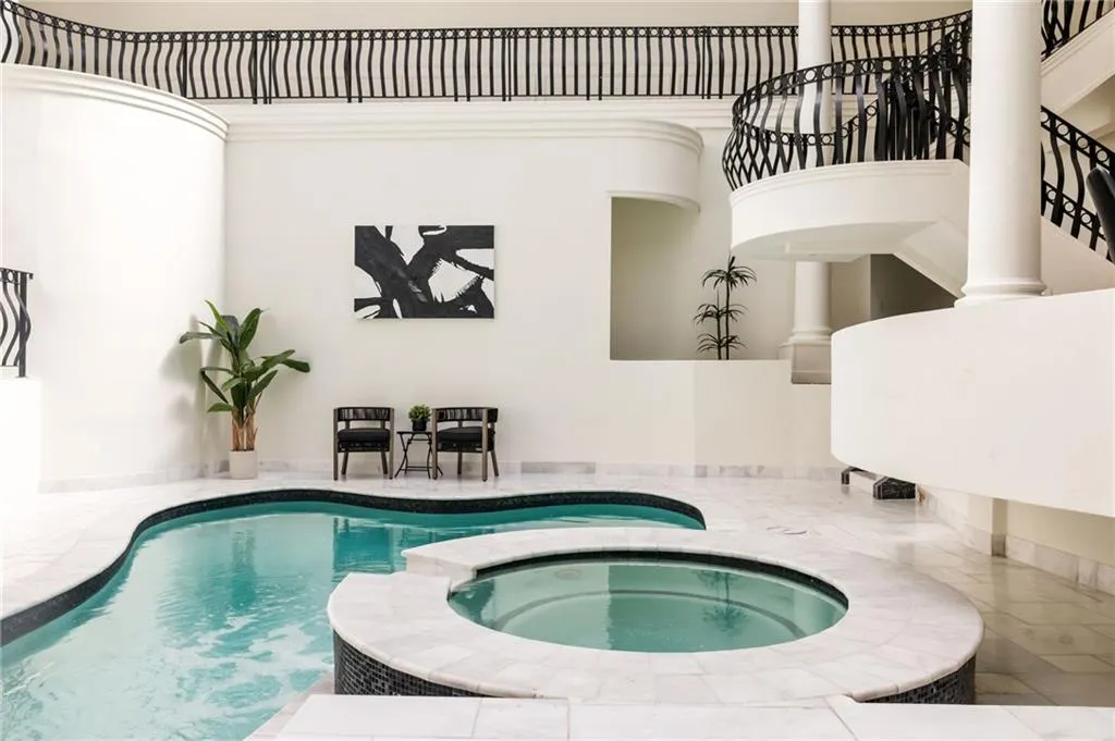 View of swimming pool featuring a pool with connected hot tub