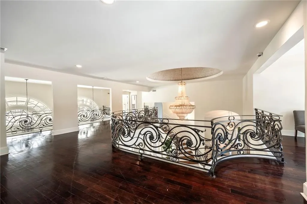 Stairs featuring a chandelier, recessed lighting, and wood-type flooring