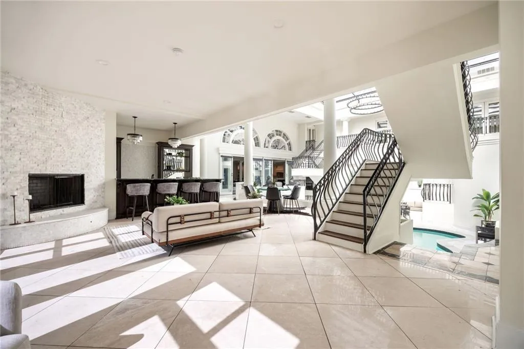 Tiled living room with stairway and a fireplace