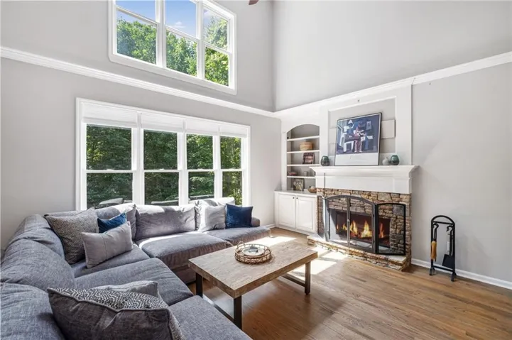 Two story fireside family room with built-in shelving.