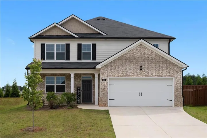 Contemporary two-story residence featuring a brick and siding facade, a two-car garage with a concrete driveway, a covered front porch with white columns, and a dark front door