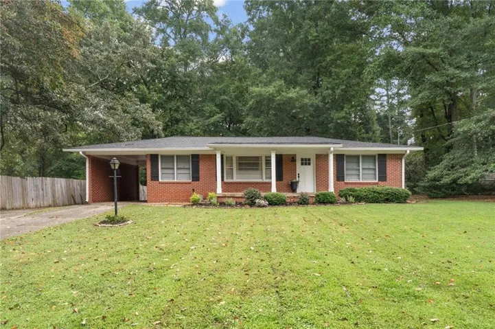 Brick exterior with a covered front porch featuring white columns