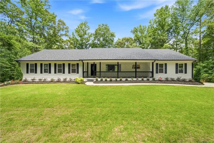 Ranch which is completely renovated  with finished terrace level on a lake with over 5 wood acres