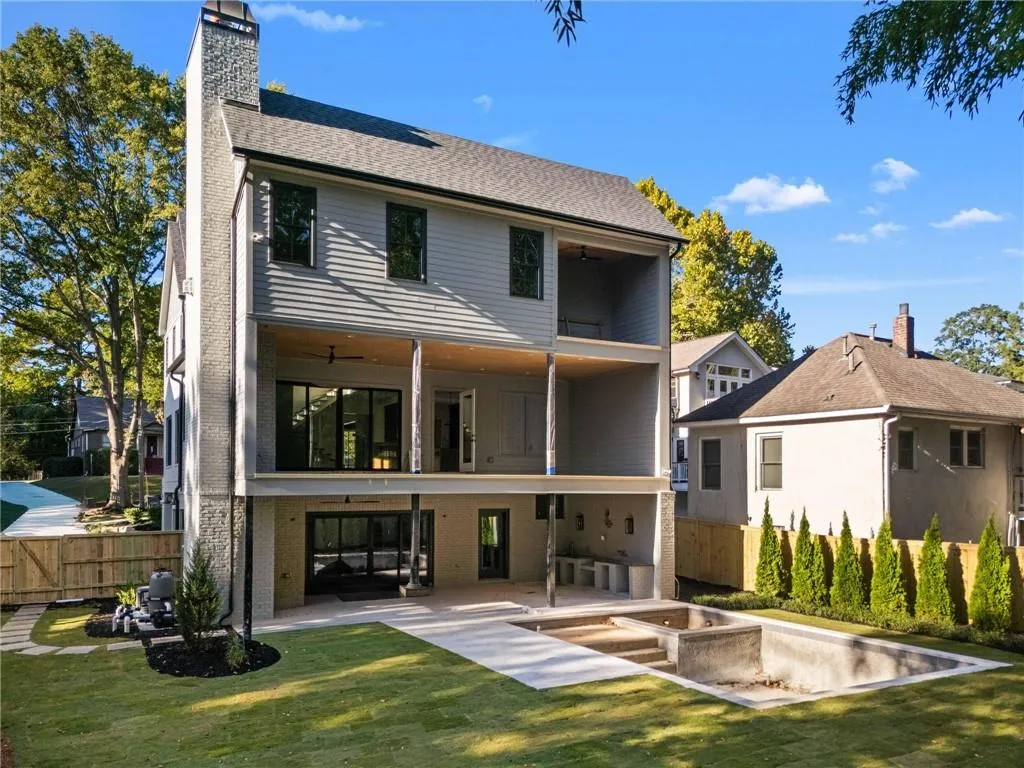 Rear view of property featuring ceiling fan, a patio, a fenced backyard, and a chimney