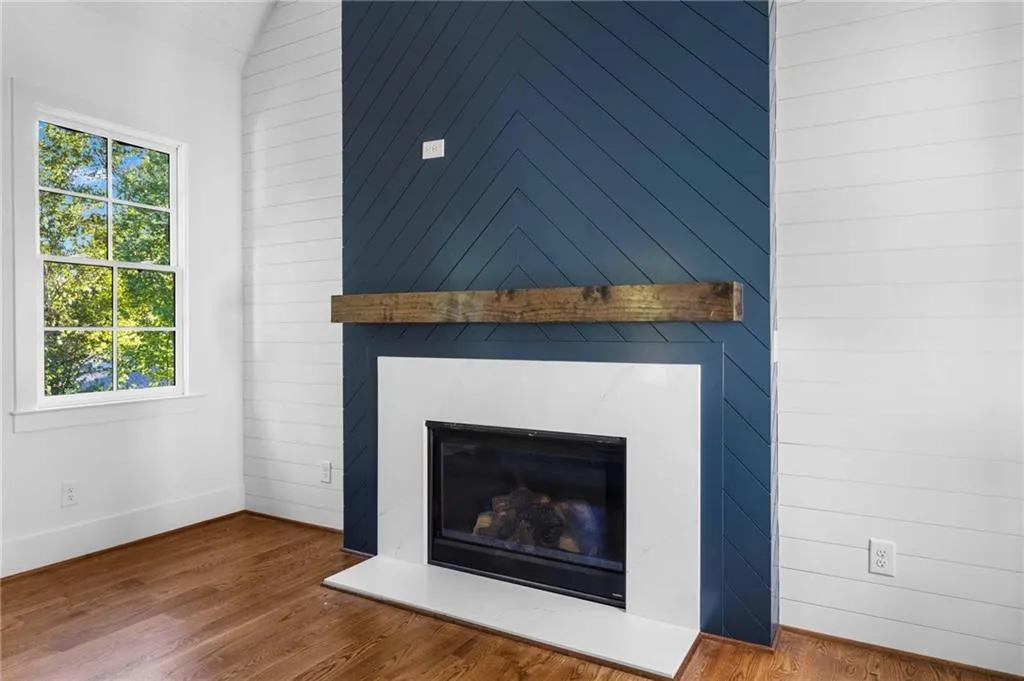 Detailed view of a large fireplace and wood finished floors