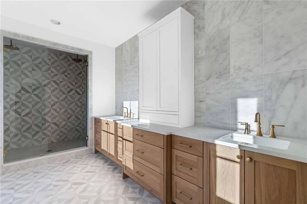 Bathroom with tile walls and a stall shower