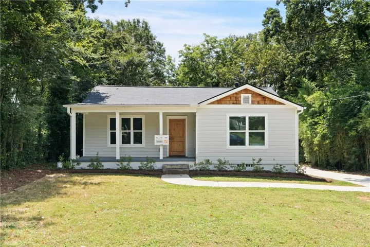 View of front of home with a front lawn and covered porch