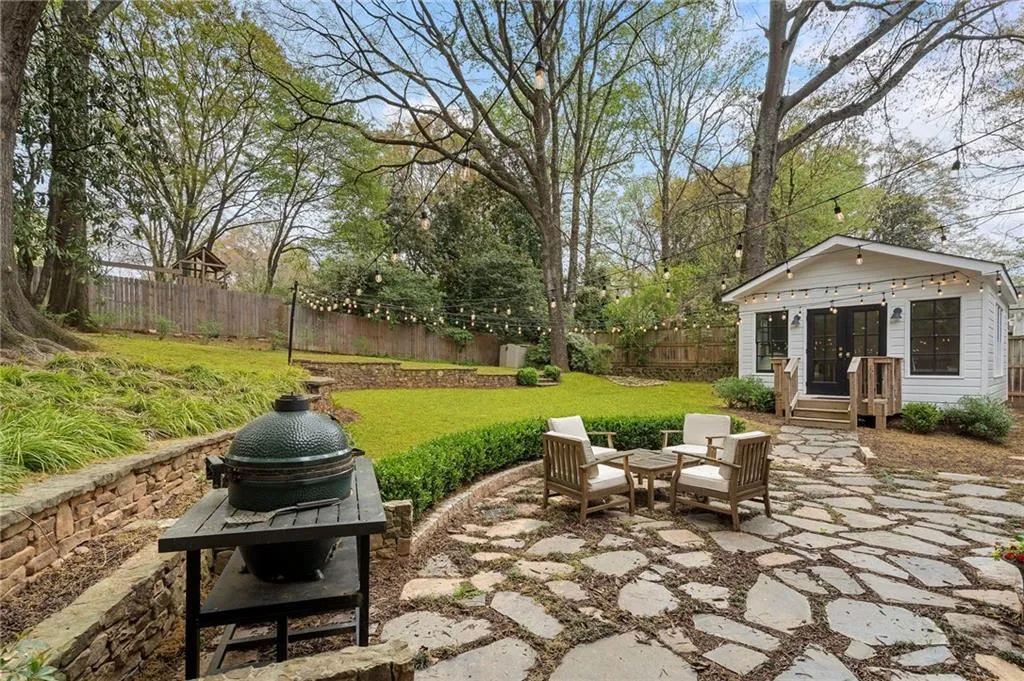 Walk out stone patio overlooking large back yard