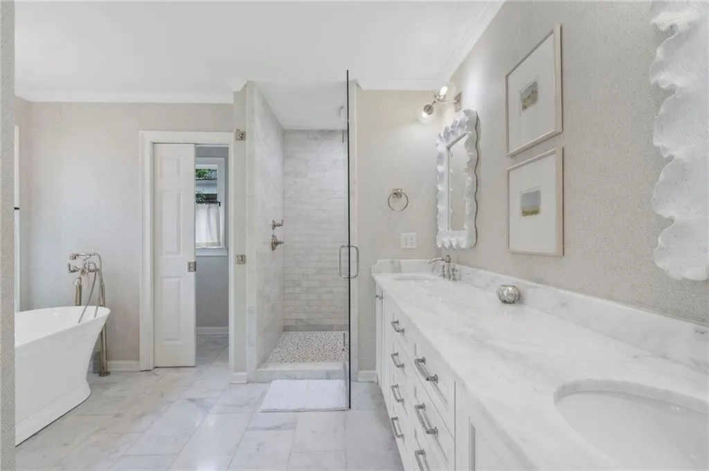 Primary bathroom completely renovated in 2021 is a peaceful sanctuary with a separate soaking tub and shower.