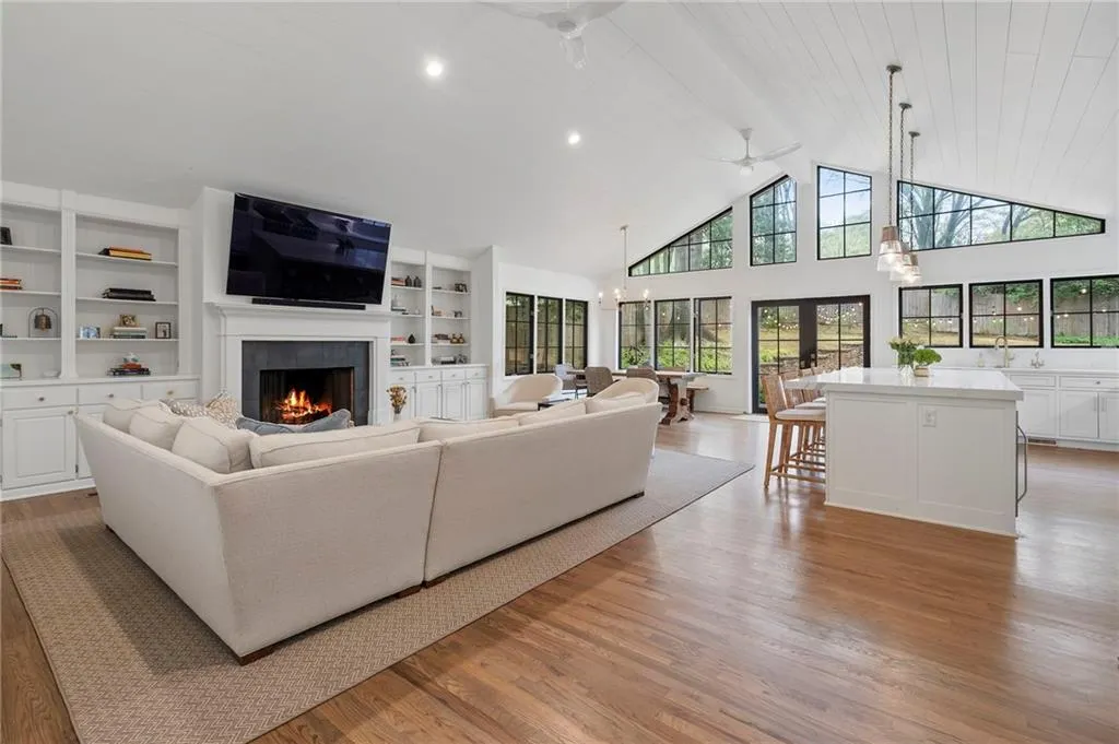 Large family room with vaulted ceiling opens to chef's kitchen