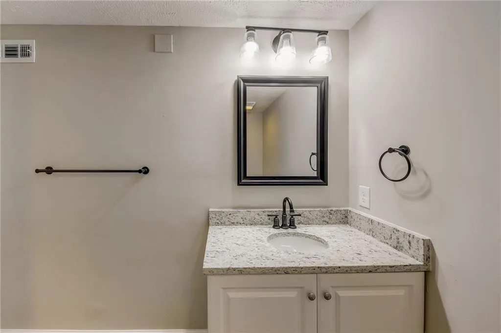 Bathroom with vanity and a textured ceiling