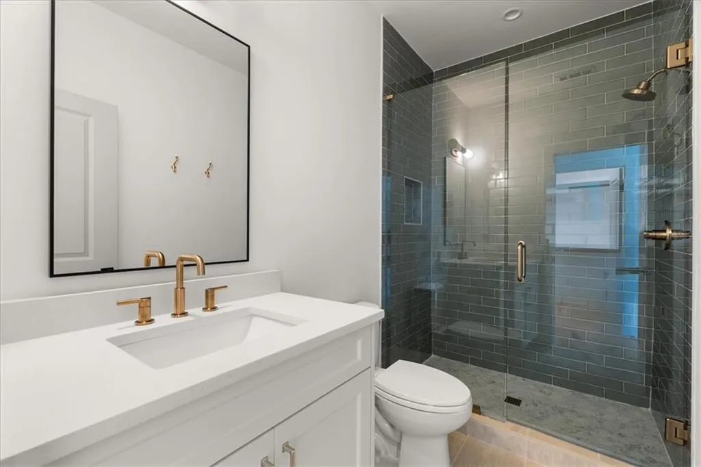 Full bathroom with vanity and a shower stall
